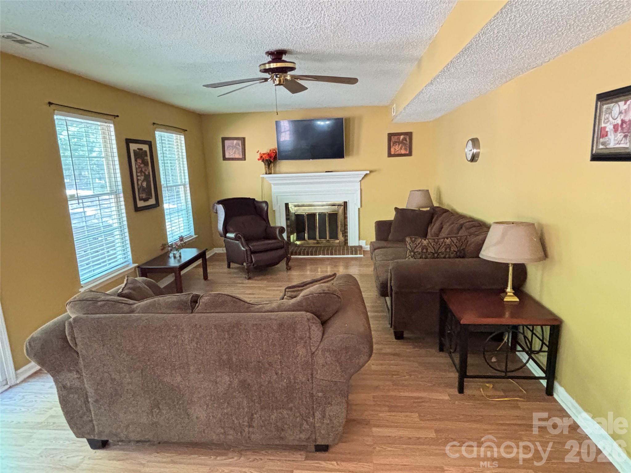 2601 Yarrow Road Charlotte, NC 28213 - Photo 18 of 40 a living room with furniture a fireplace and a flat screen tv