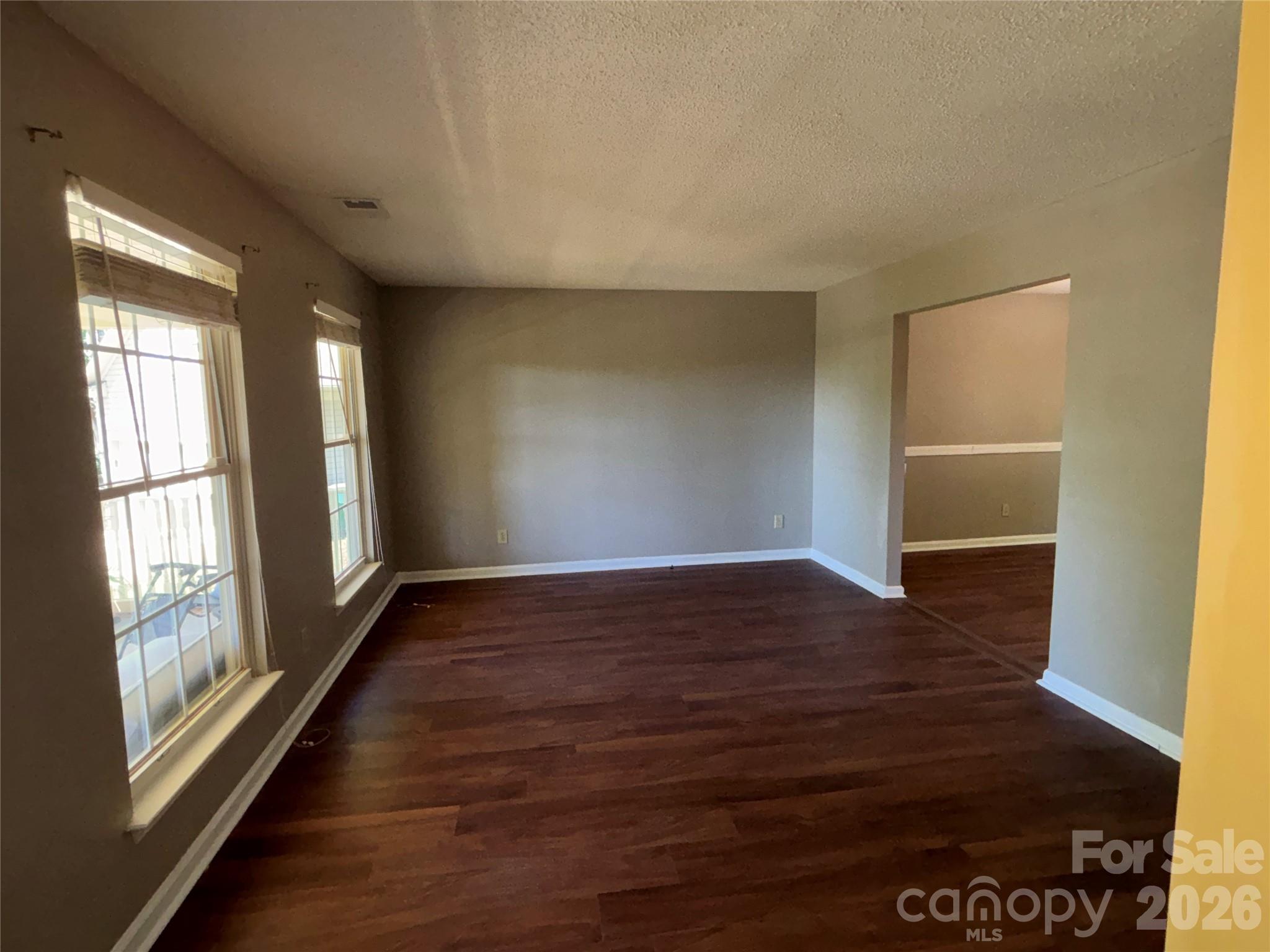 2601 Yarrow Road Charlotte, NC 28213 - Photo 6 of 40 a view of an empty room with wooden floor and a window