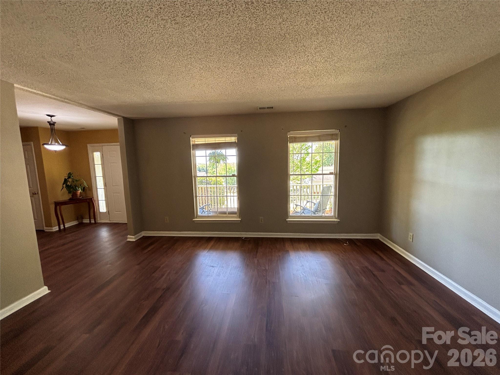 2601 Yarrow Road Charlotte, NC 28213 - Photo 7 of 40 an empty room with wooden floor and windows