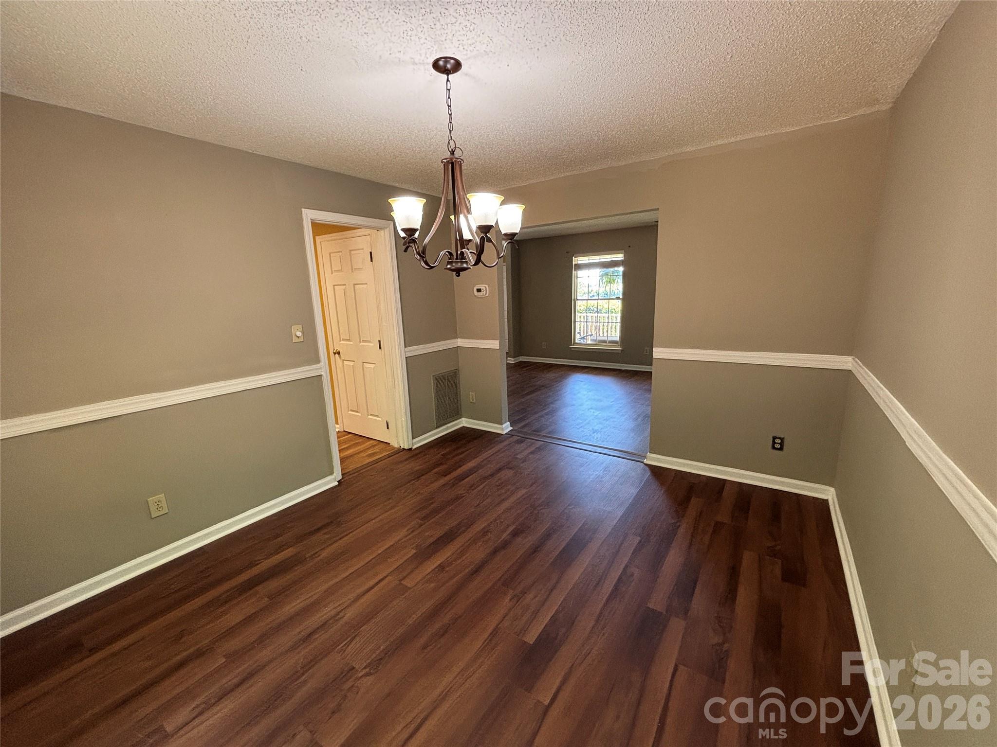 2601 Yarrow Road Charlotte, NC 28213 - Photo 8 of 40 a view of livingroom with hardwood floor and kitchen view
