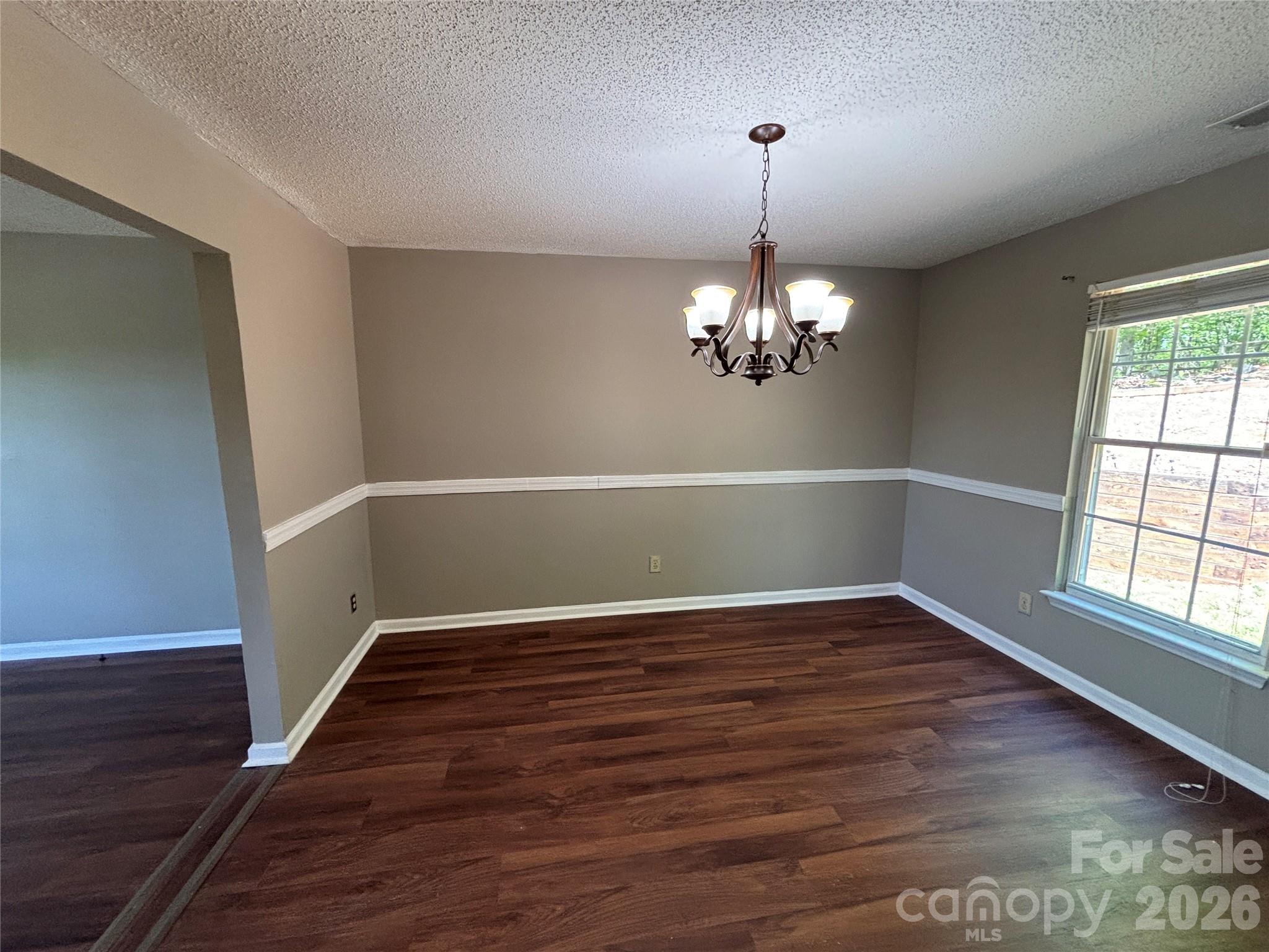 2601 Yarrow Road Charlotte, NC 28213 - Photo 9 of 40 a view of an empty room with wooden floor and a window