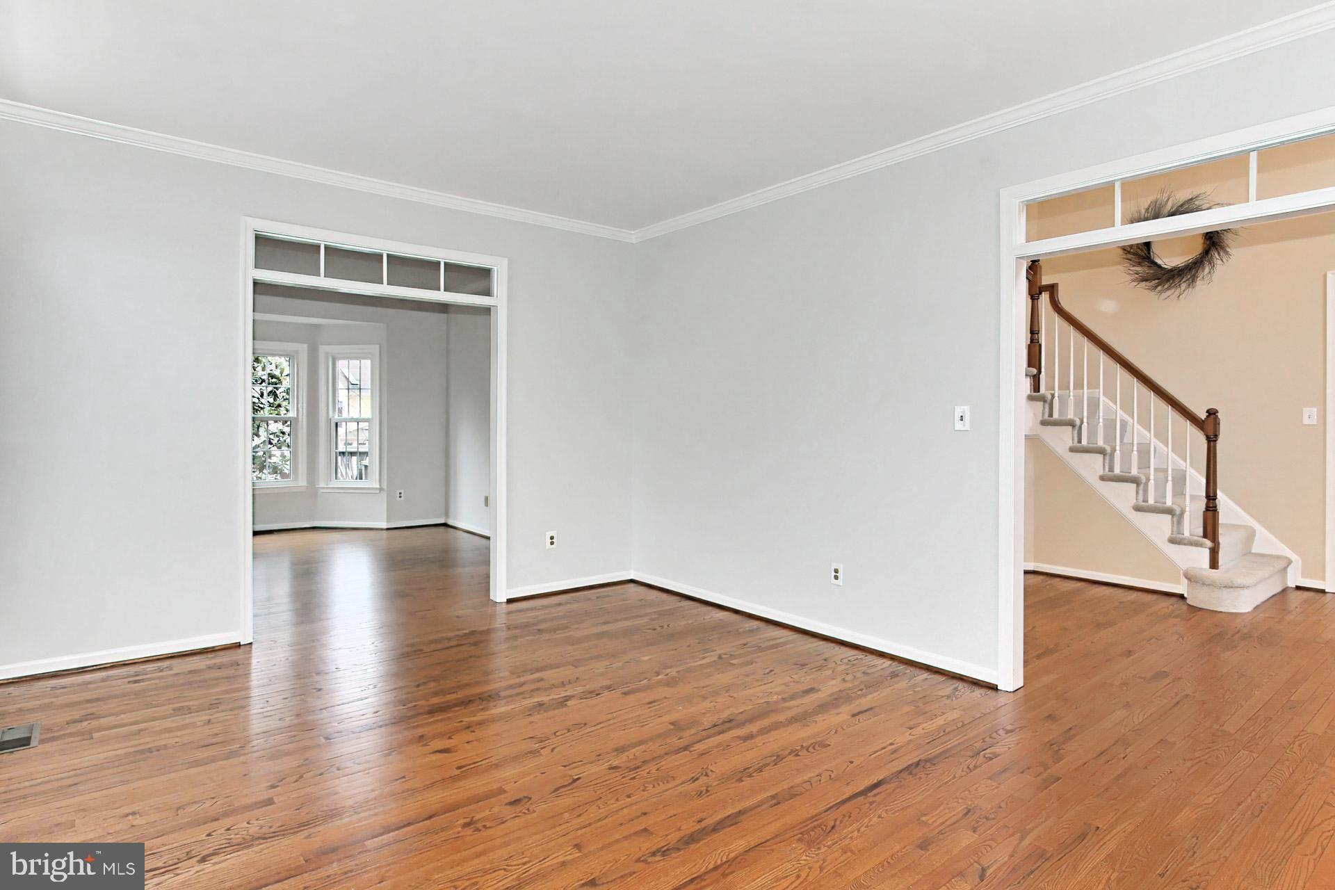 8126 Ridge Creek Way Springfield, VA 22153 - Photo 7 of 50 a view of an empty room with wooden floor and a window