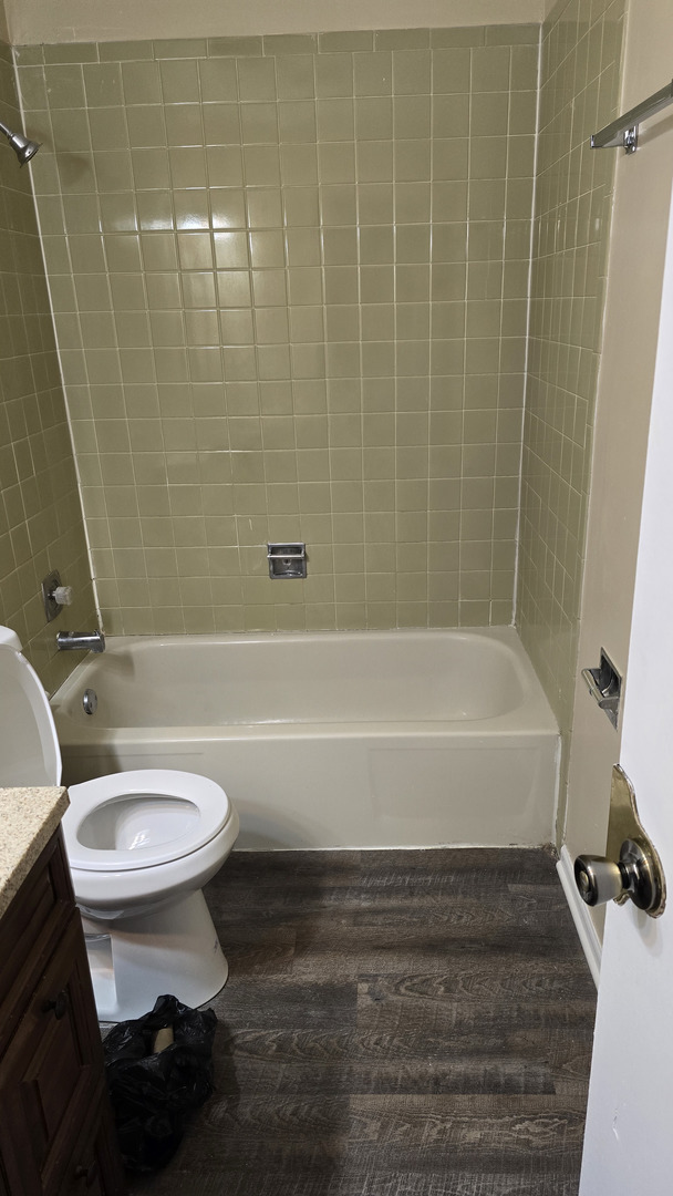 4052 Charleston Road, Unit 2E Matteson, IL 60443 - Photo 4 of 5 a bathroom with a toilet a sink and bathtub