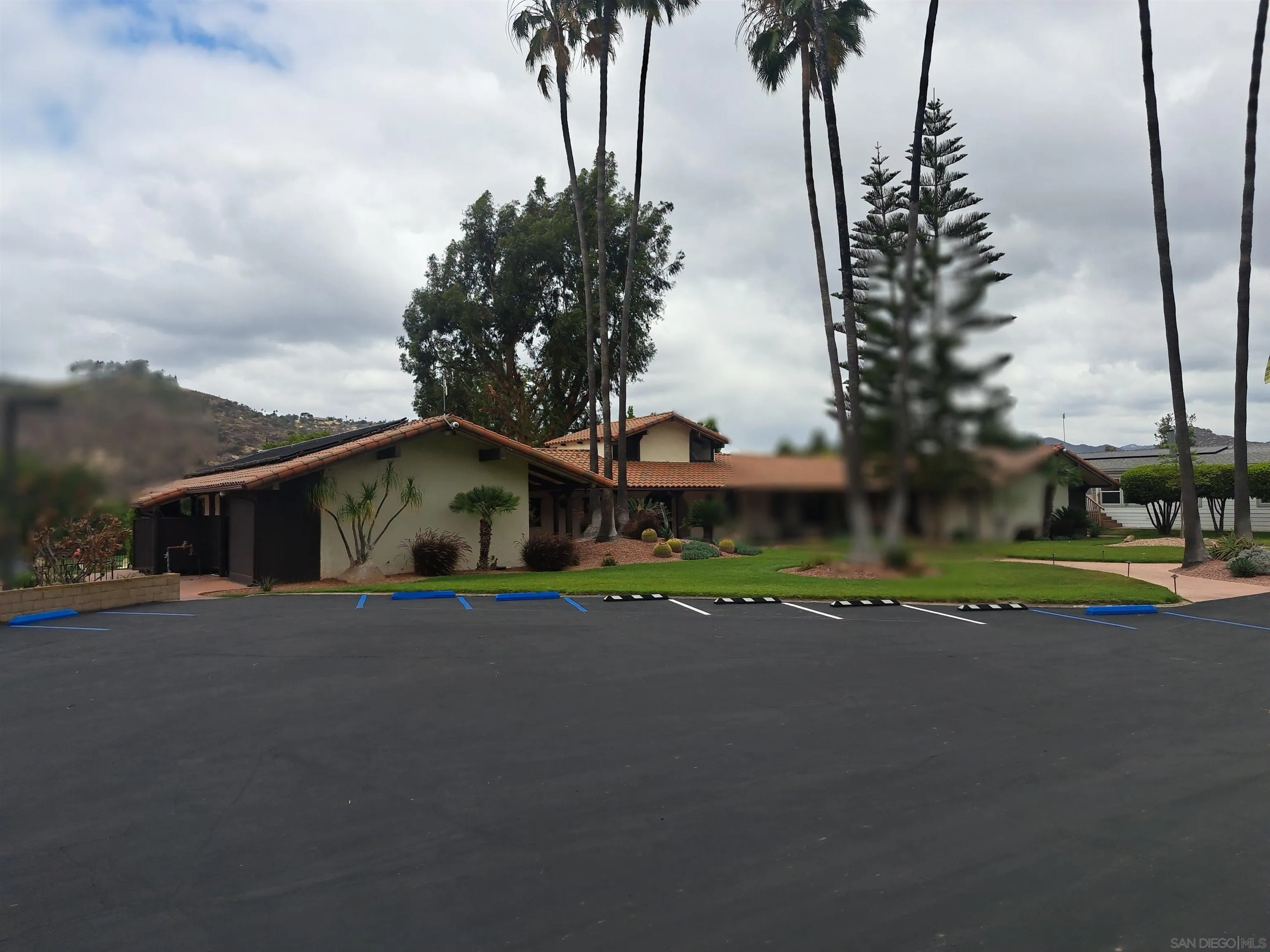4650 Dulin Road, Unit 12 Fallbrook, CA 92003 - Photo 29 of 36 a view of a house with a yard and palm trees