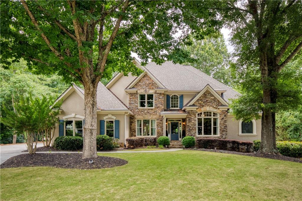 a front view of a house with a garden
