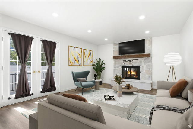 1676 East 11245 South Sandy, UT 84092 - Photo 4 of 34 Living area featuring a stone fireplace with a wood mantle, wood-finish flooring, and recessed lighting. This photo is virtually staged.