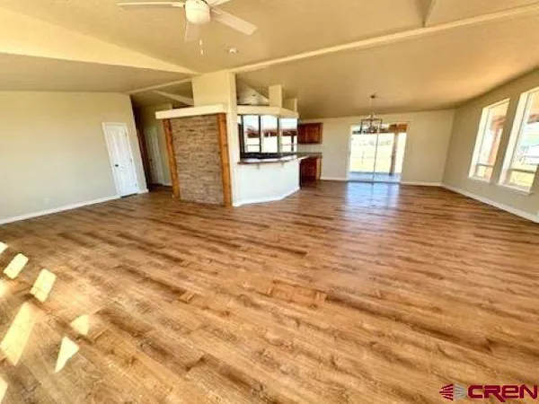 a view of a room with wooden floor and large windows