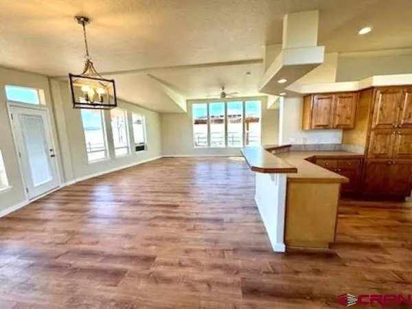 a kitchen with stainless steel appliances granite countertop a sink and a wooden floors