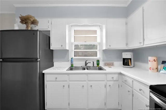 a kitchen with appliances cabinets and a window