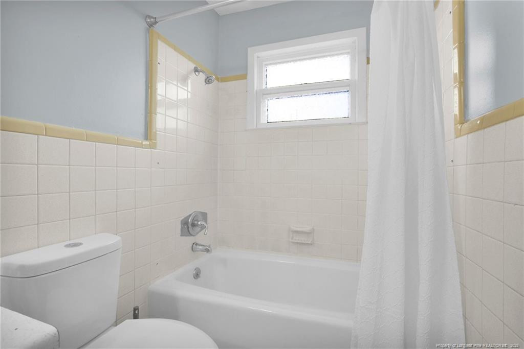 623 Isaac Weeks Road Clinton, NC 28328 - Photo 18 of 24 a white bath tub sitting next to a white toilet and a shower