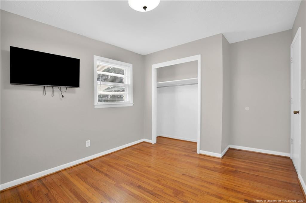 623 Isaac Weeks Road Clinton, NC 28328 - Photo 22 of 24 a view of empty room with wooden floor and flat screen tv