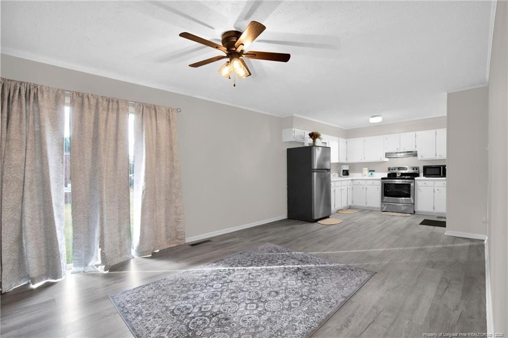 623 Isaac Weeks Road Clinton, NC 28328 - Photo 8 of 24 a view of kitchen with stainless steel appliances granite countertop cabinets and wooden floor