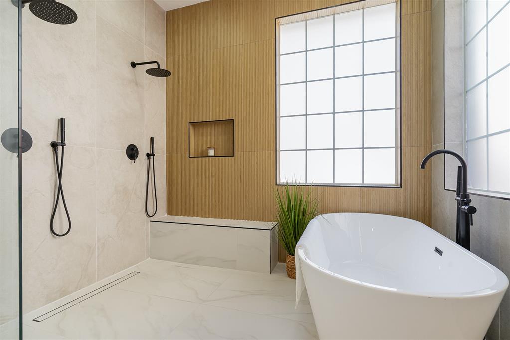 7524 Aberdon Road Dallas, TX 75252 - Photo 17 of 39 Full bath featuring tile walls, marble finish floor, a tile shower, a freestanding bath, and a sink