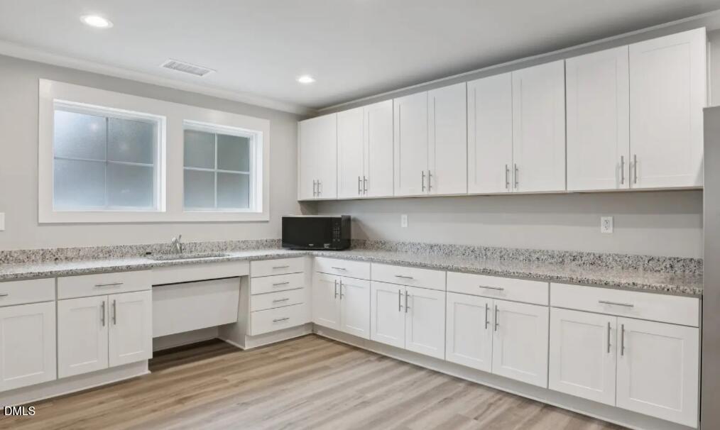 308 Karlov Road Garner, NC 27529 - Photo 54 of 55 a kitchen with granite countertop white cabinets and a sink