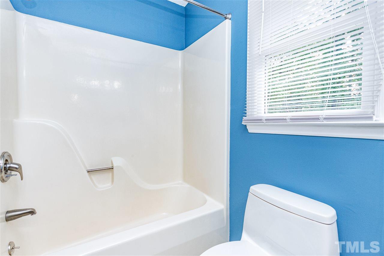 1022 Dove Ridge Road Bahama, NC 27503 - Photo 14 of 27 a white toilet sitting next to a bath tub