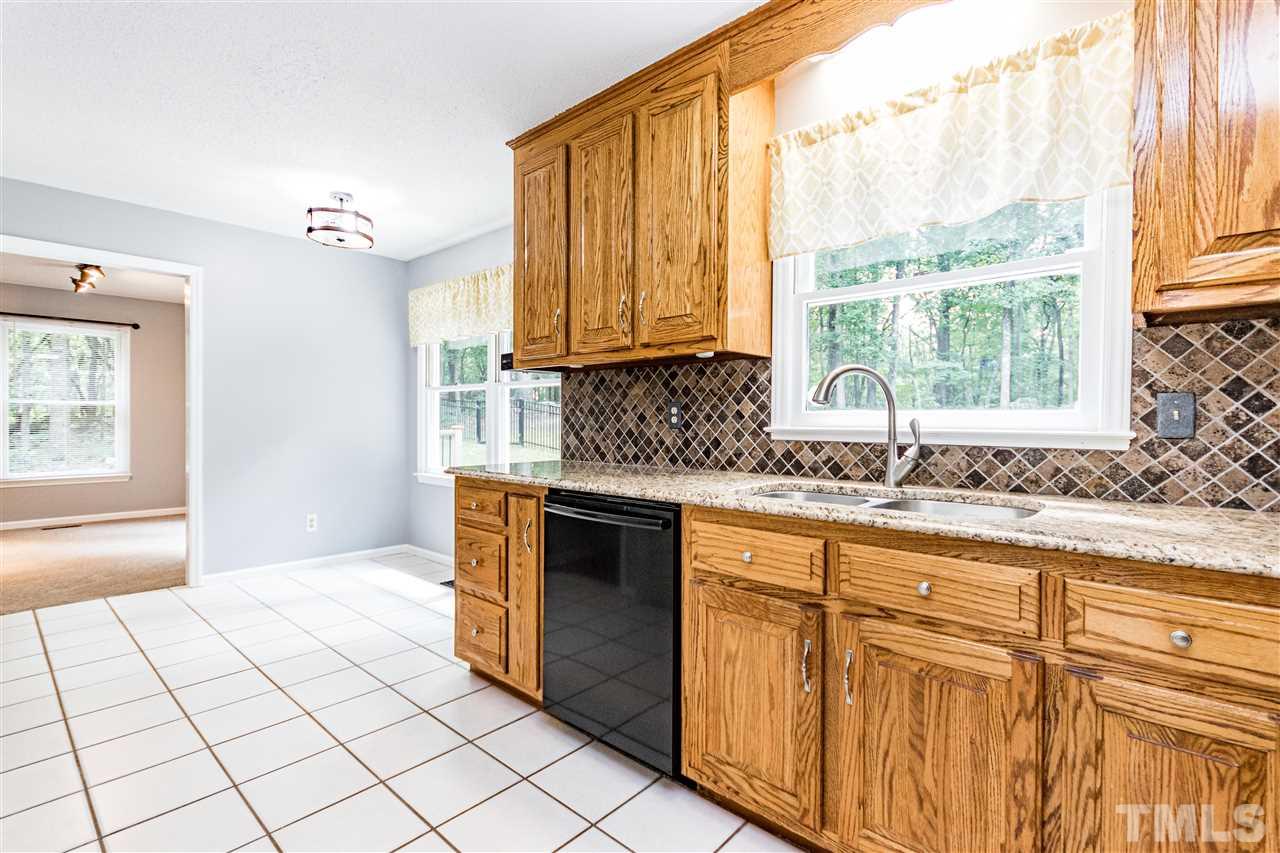 1022 Dove Ridge Road Bahama, NC 27503 - Photo 7 of 27 a kitchen with granite countertop a sink and a stove