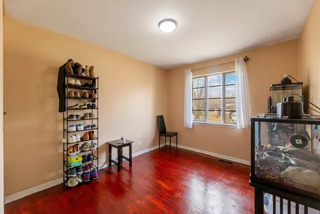 a view of a room with gym equipment and wooden floor