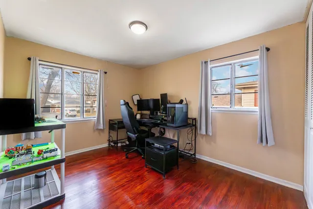 a view of a workspace with furniture and a window