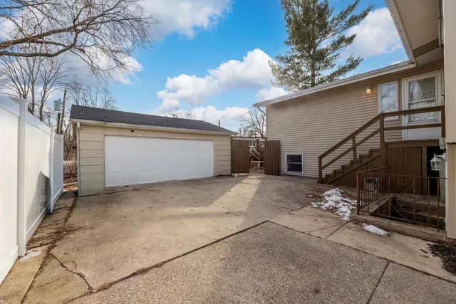 a view of a house with a yard and garage