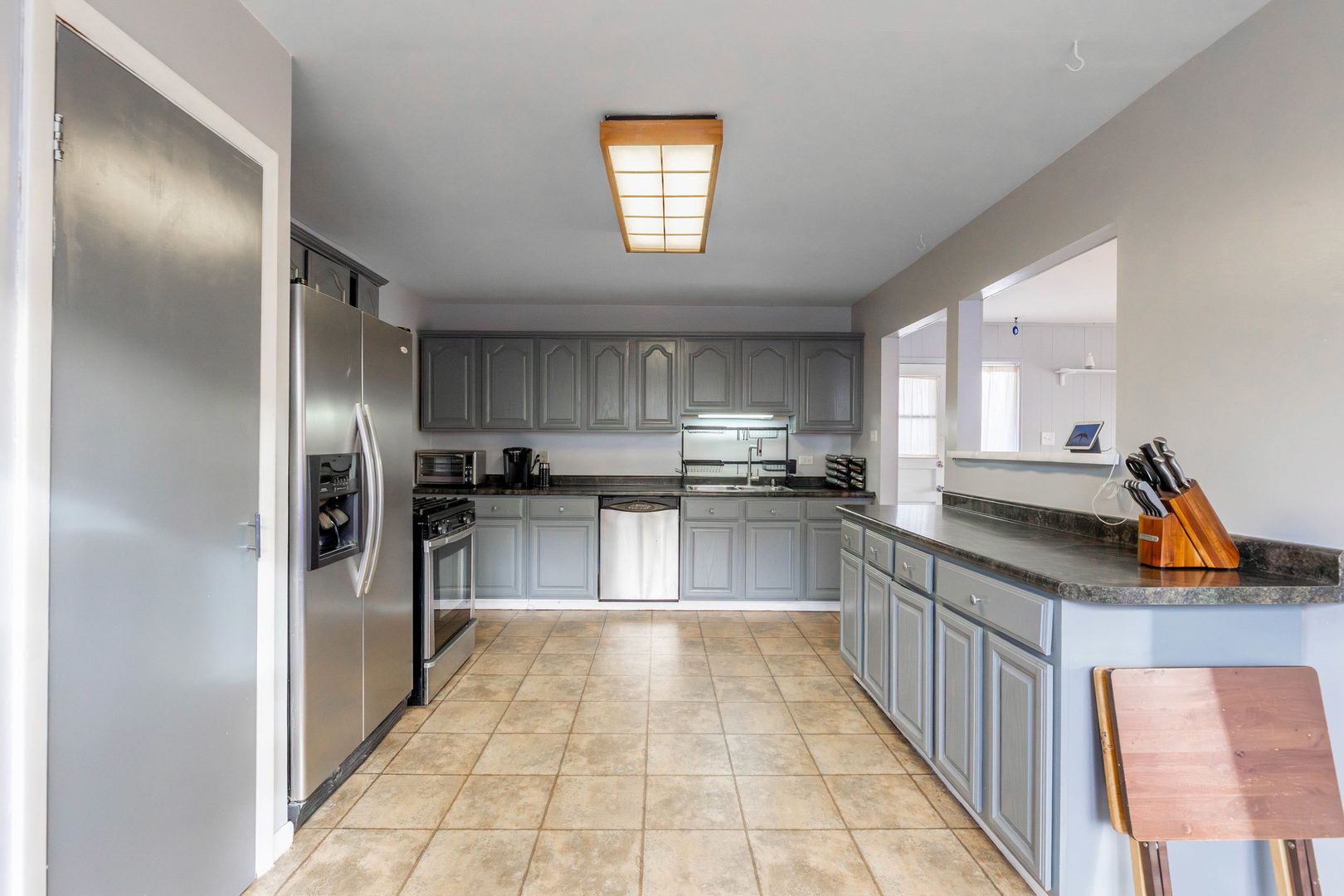 313 Jackson Street Park Forest, IL 60466 - Photo 5 of 22 a kitchen with stainless steel appliances granite countertop a refrigerator and a sink