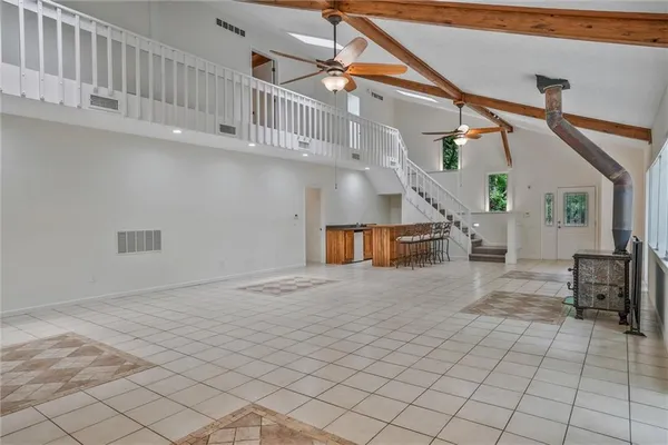 an empty room with windows and entrance