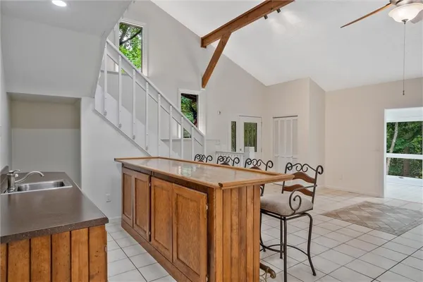 a view of a room with wooden floor and a ceiling fan