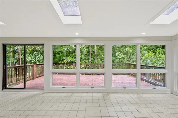 a view of a small space with wooden floor and a window