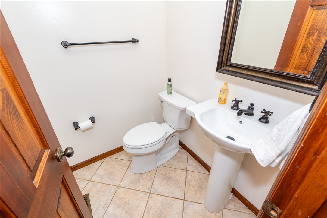 6750 Little Twin Road Germantown, OH 45327 - Photo 15 of 88 This convenient bathroom features a modern pedestal sink and tiled flooring.