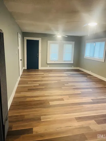 a view of a room with wooden floor and cabinet