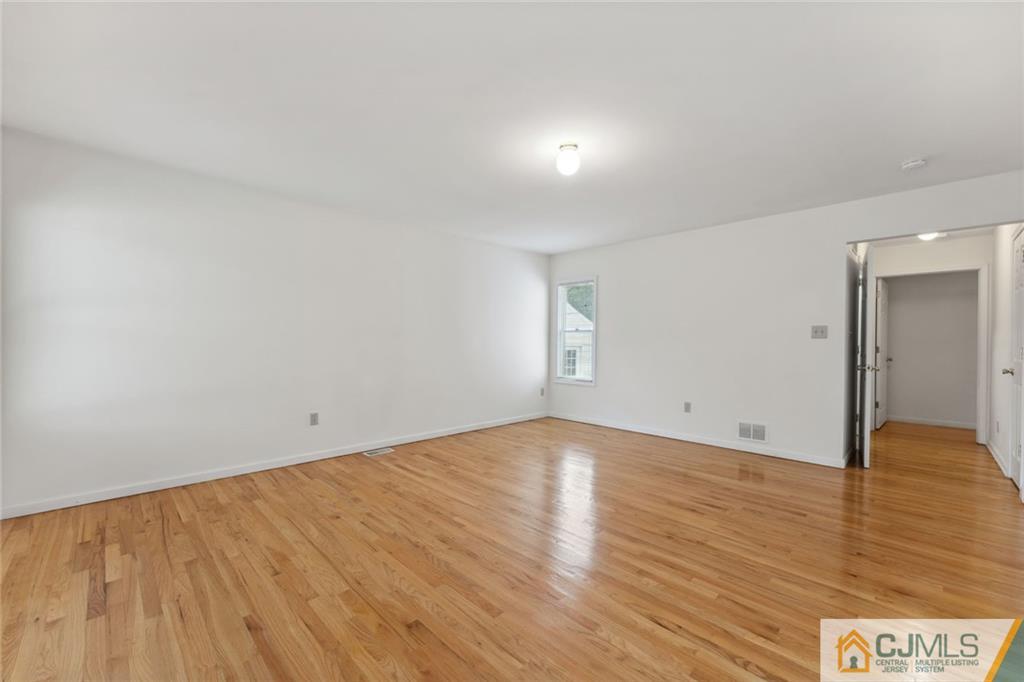 8 Longfellow Drive Colonia, NJ 07067 - Photo 12 of 25 a view of an empty room and wooden floor