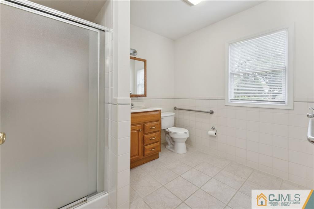 8 Longfellow Drive Colonia, NJ 07067 - Photo 13 of 25 a bathroom with a toilet sink and shower