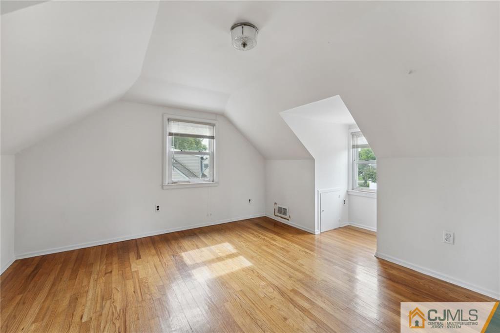 8 Longfellow Drive Colonia, NJ 07067 - Photo 15 of 25 an empty room with wooden floor and windows