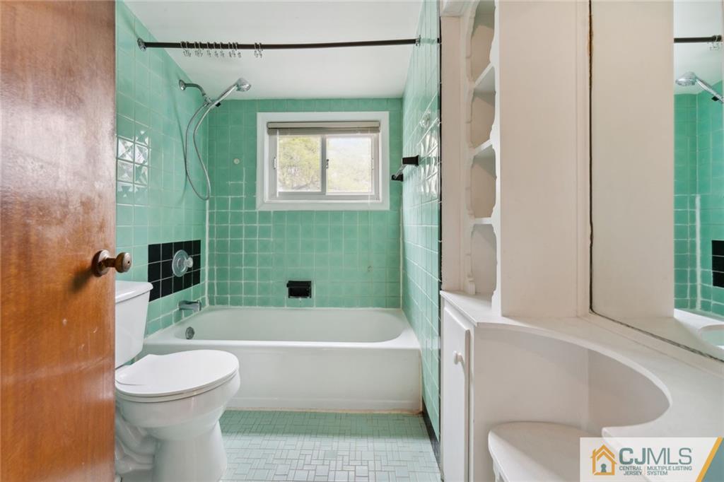 8 Longfellow Drive Colonia, NJ 07067 - Photo 17 of 25 a bathroom with a sink a toilet and a bathtub