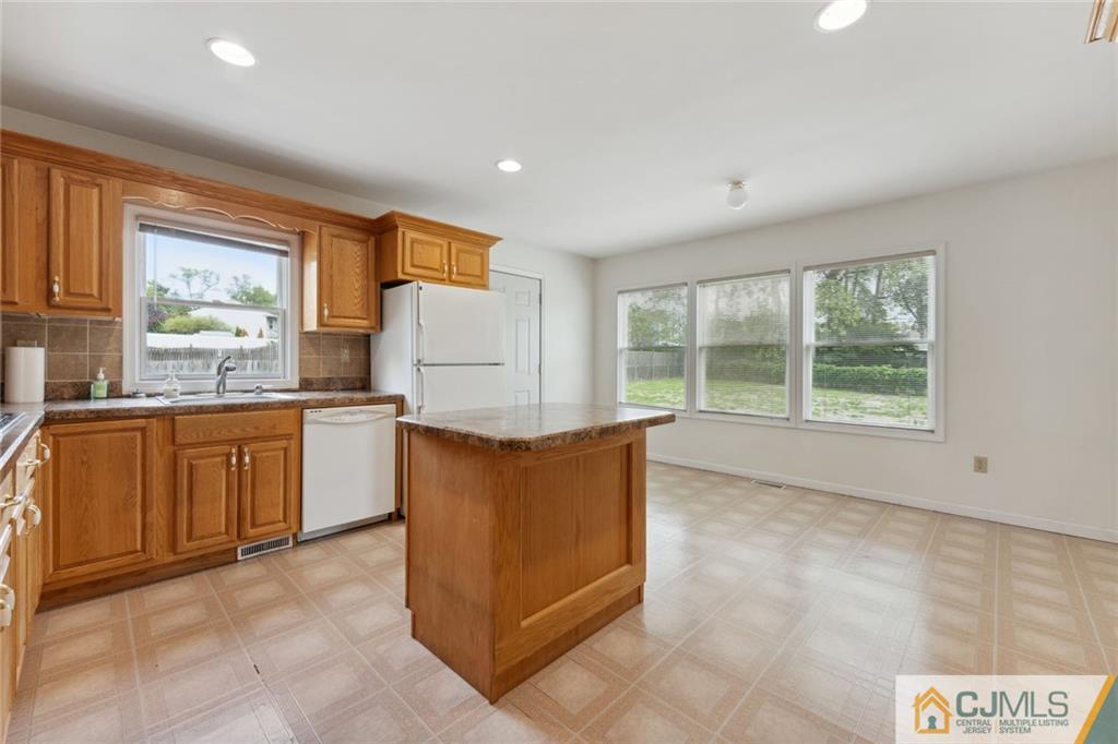 8 Longfellow Drive Colonia, NJ 07067 - Photo 7 of 25 a kitchen with sink cabinets and window