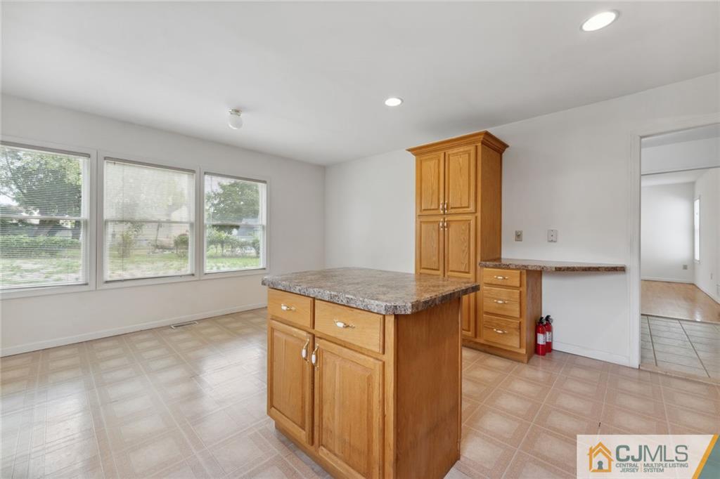 8 Longfellow Drive Colonia, NJ 07067 - Photo 8 of 25 an empty room with window and kitchen view