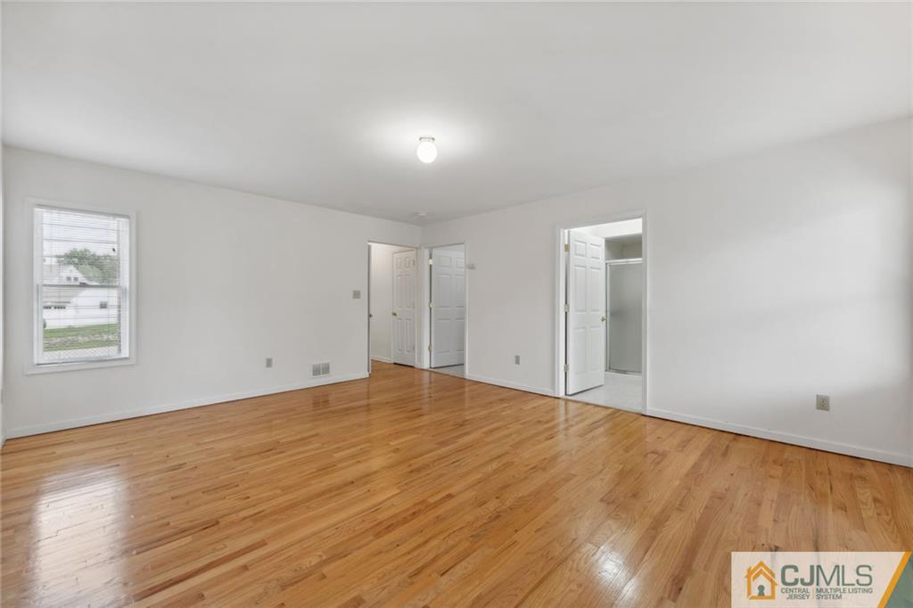 8 Longfellow Drive Colonia, NJ 07067 - Photo 10 of 25 a view of an empty room with wooden floor