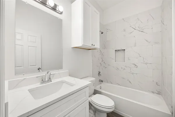 a bathroom with a sink a toilet and a bathtub