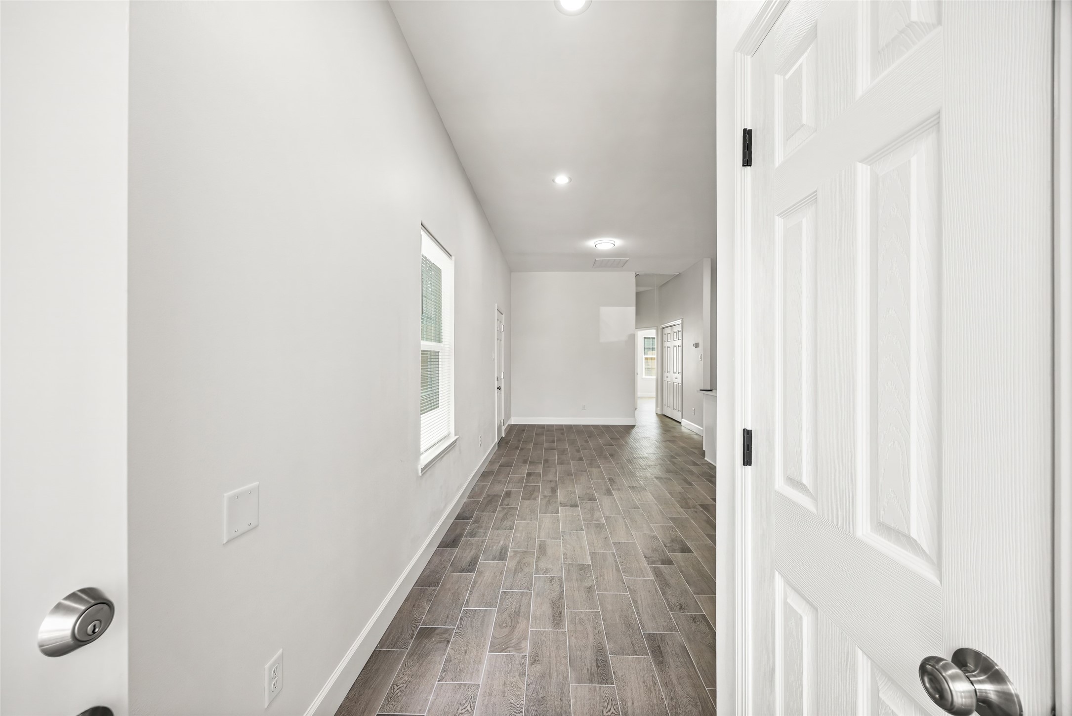 1546 Lombardy Street Houston, TX 77023 - Photo 4 of 15 a view of a hallway with wooden floor and closet