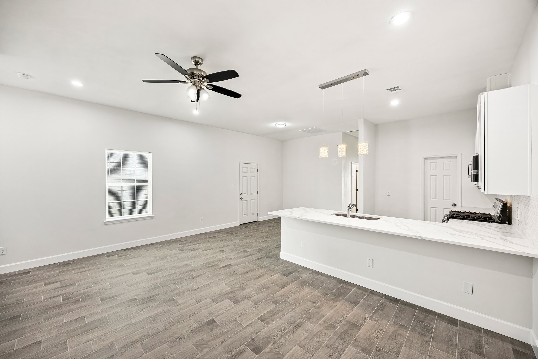 1546 Lombardy Street Houston, TX 77023 - Photo 6 of 15 a large white kitchen with a large window