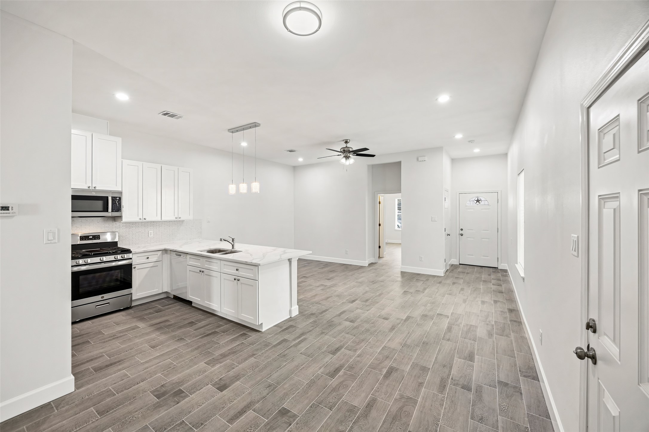 1546 Lombardy Street Houston, TX 77023 - Photo 7 of 15 a kitchen with a refrigerator and a stove top oven