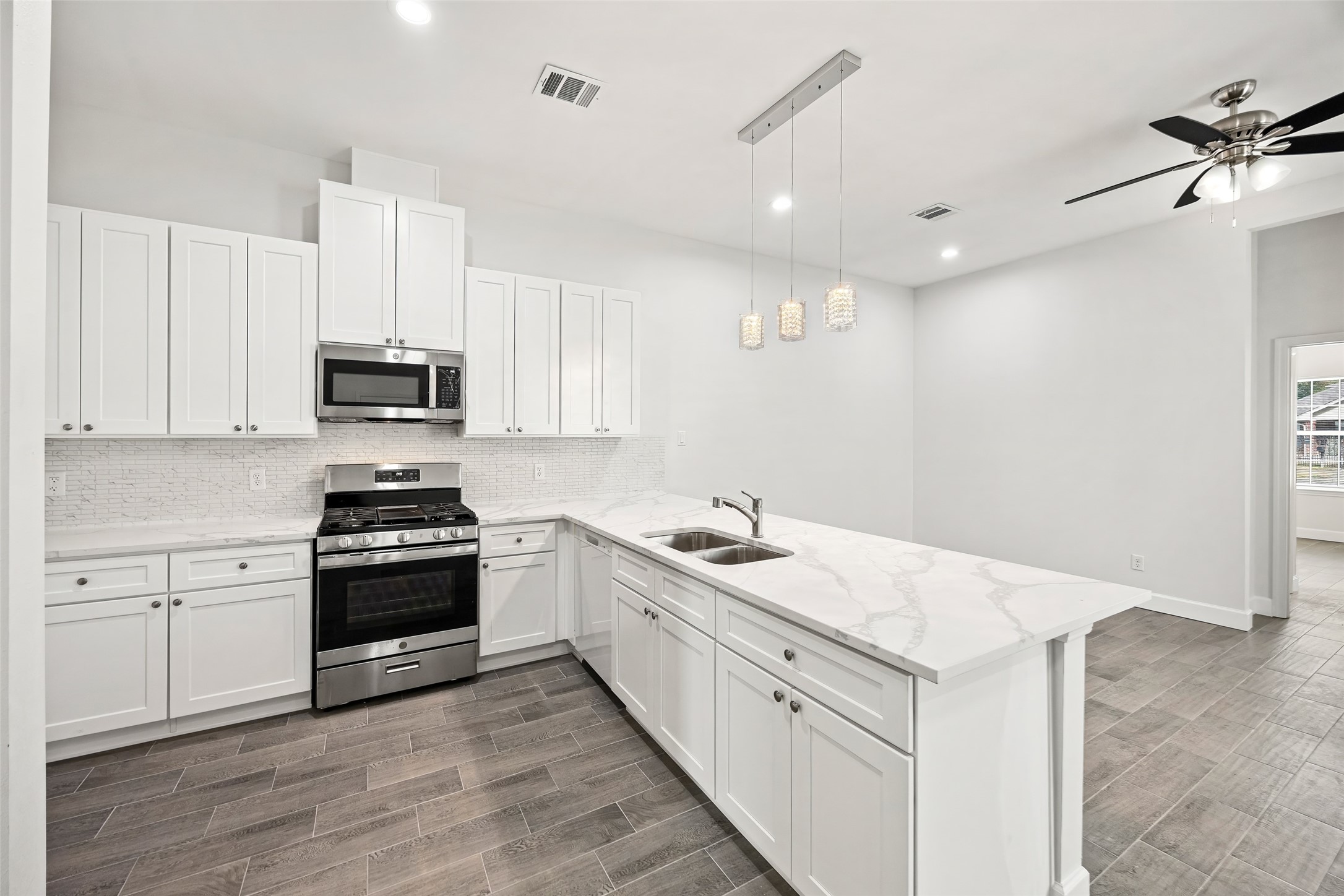1546 Lombardy Street Houston, TX 77023 - Photo 9 of 15 a kitchen with stainless steel appliances granite countertop a sink stove and refrigerator
