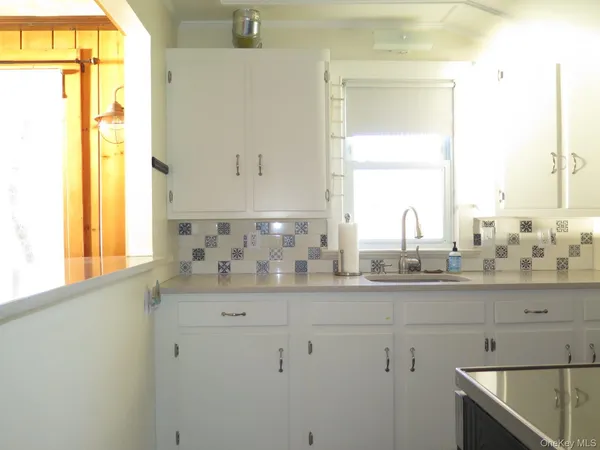 a bathroom with a sink and a window