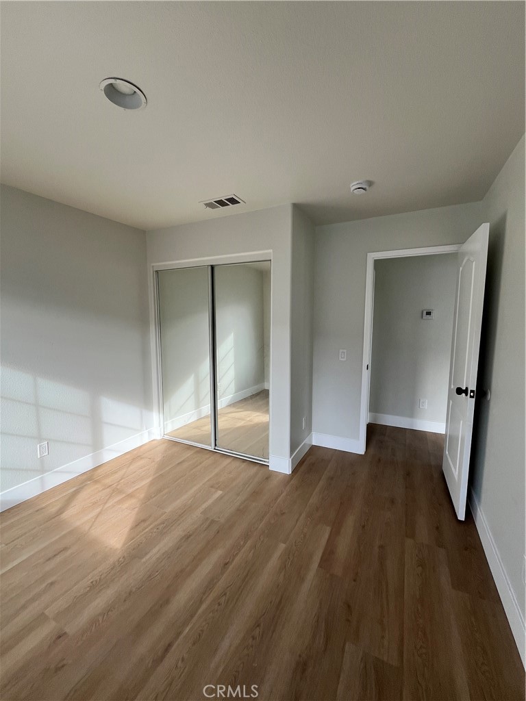 1004 South Riverside Avenue, Unit C1 Rialto, CA 92376 - Photo 14 of 19 a view of an empty room and wooden floor