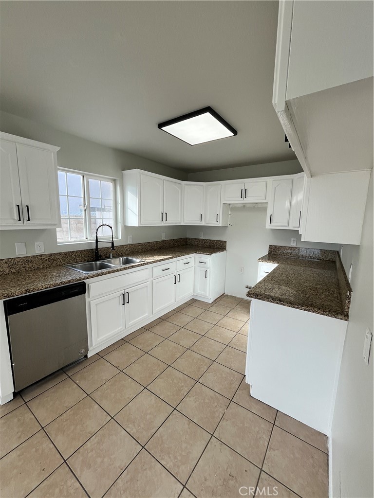 1004 South Riverside Avenue, Unit C1 Rialto, CA 92376 - Photo 6 of 19 a kitchen with stainless steel appliances granite countertop a sink a stove a microwave and cabinets