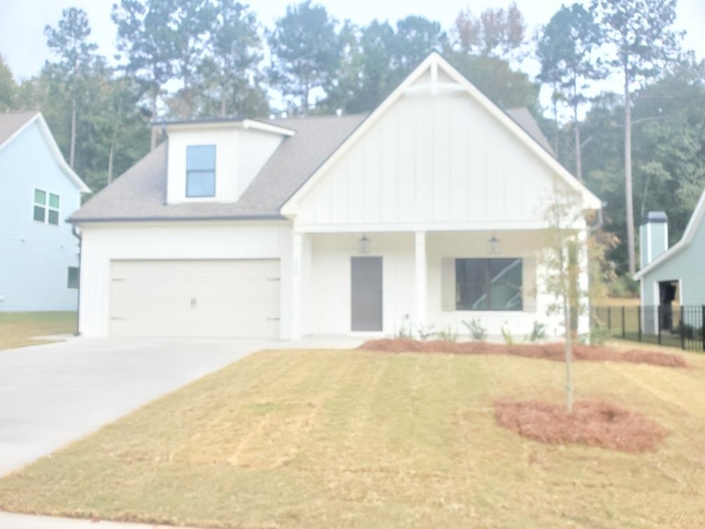 230 S Ridge, Unit 14 Senoia, GA 30276 - Photo 1 of 1 a view of a white house with a outdoor space