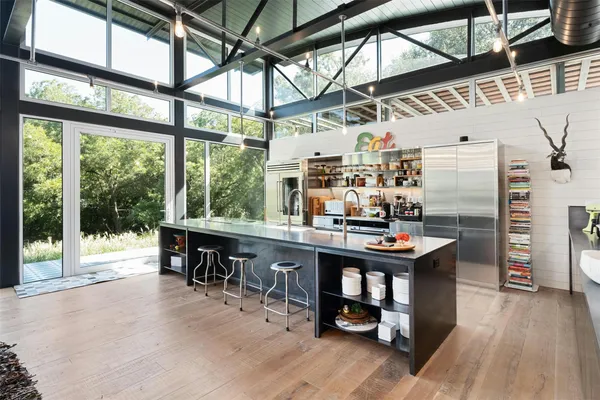 a room with lots of wooden furniture and large windows