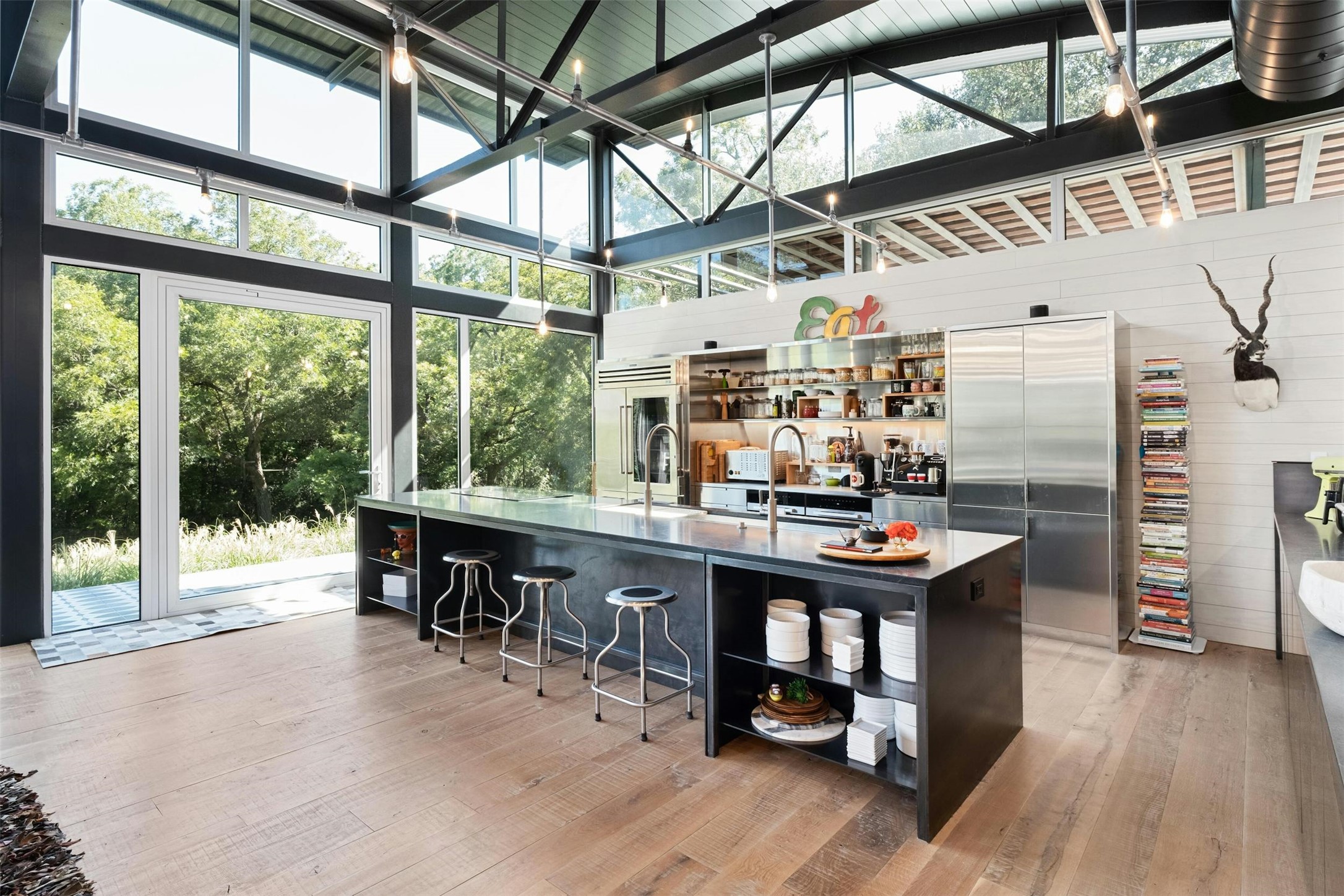 2212 River Hills Road Austin, TX 78733 - Photo 13 of 40 a room with lots of wooden furniture and large windows