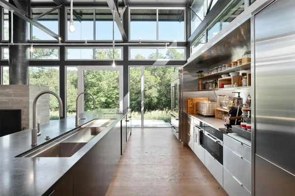 a kitchen with stainless steel appliances granite countertop a stove and a sink