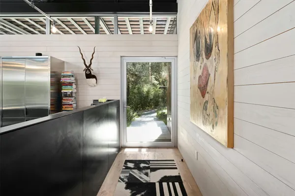 a spacious bedroom with a bed and wooden floor