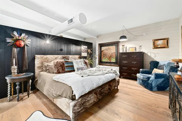 a large bed sitting in a bedroom and table